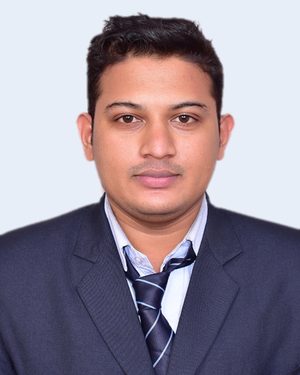 Pradipta Ray in a navy suit and striped tie